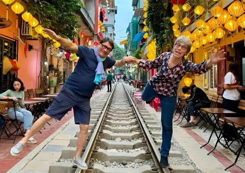Tourists posing on the famous Hanoi Train Street