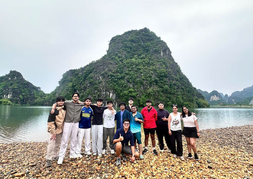 Indian travel group by limestone karst river, Vietnam
