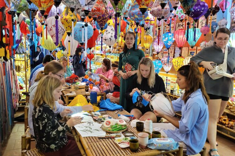 Team members crafting silk lanterns at a lantern-making workshop