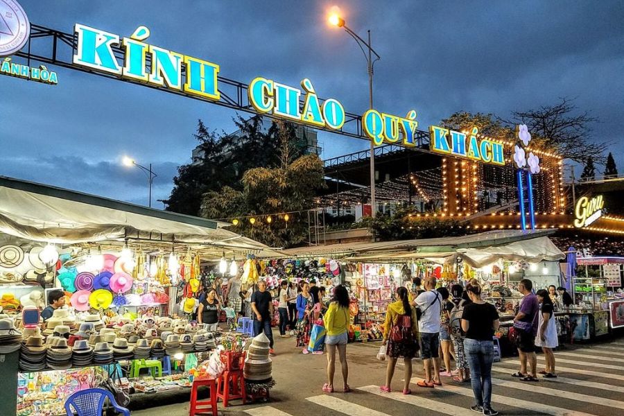 Souvenir stalls under a welcome sign at Nha Trang Night Market