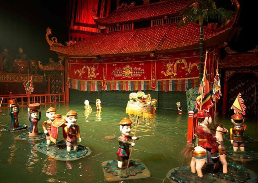 Traditional Vietnamese water puppets performing on water stage at Thang Long Water Puppet Theatre in Hanoi