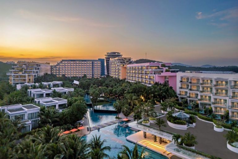 Luxury beachfront resort in Vietnam with swimming pools and palm gardens at sunset