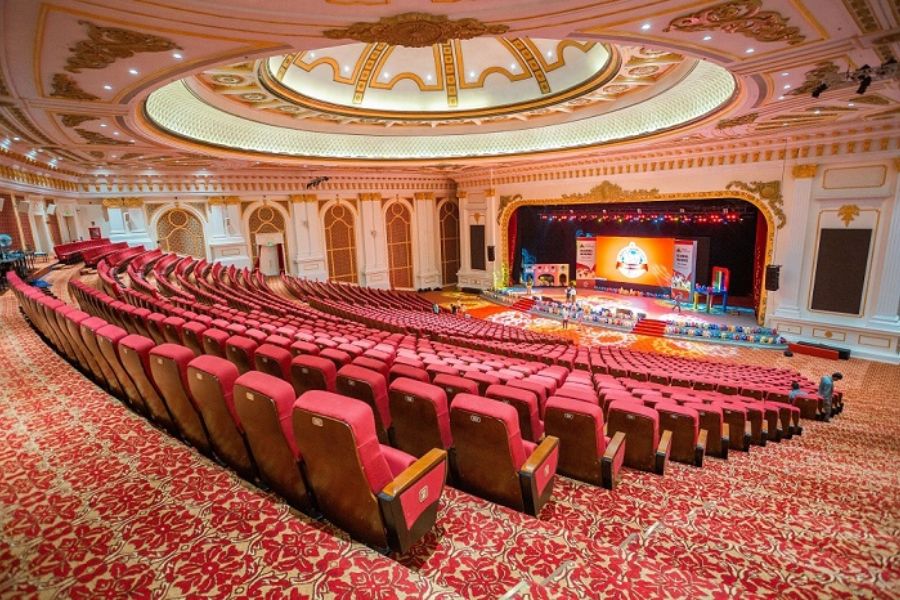 Large theatre-style hall with a stage ready for a MICE event
