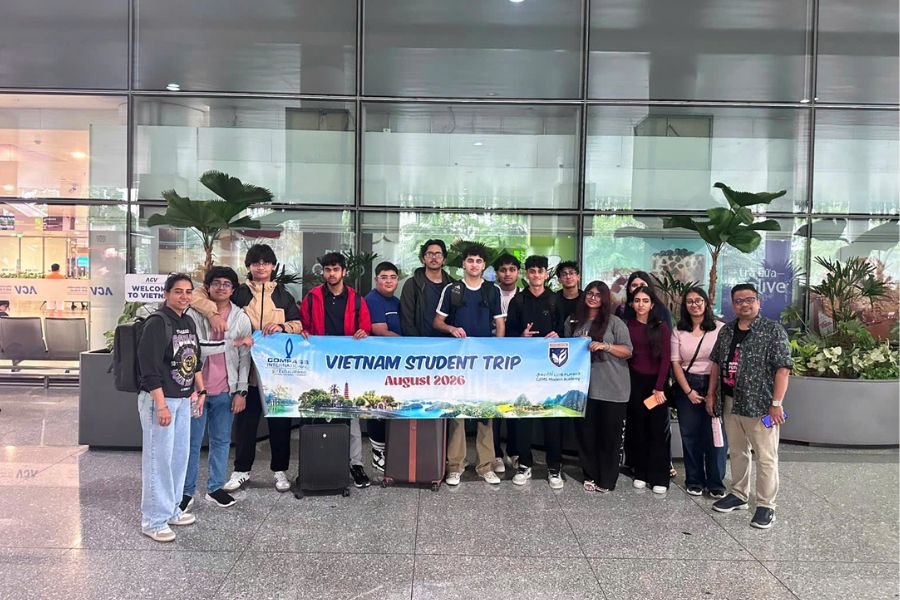 Viet Dan Travel DMC welcome Student group with a banner at the airport